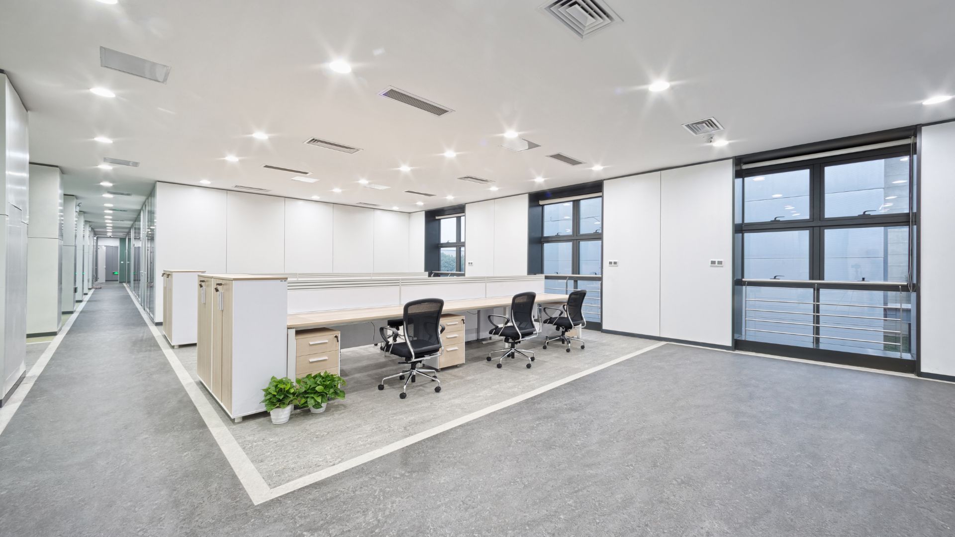 An empty office with a desk and chairs