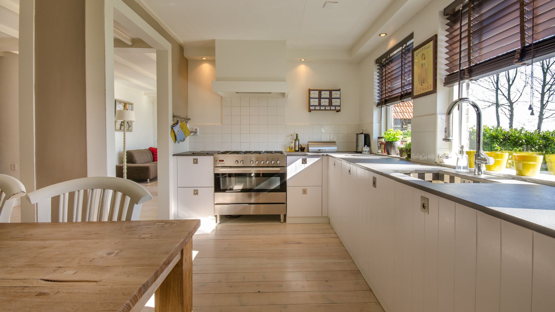 A kitchen with a wooden table and white cabinets